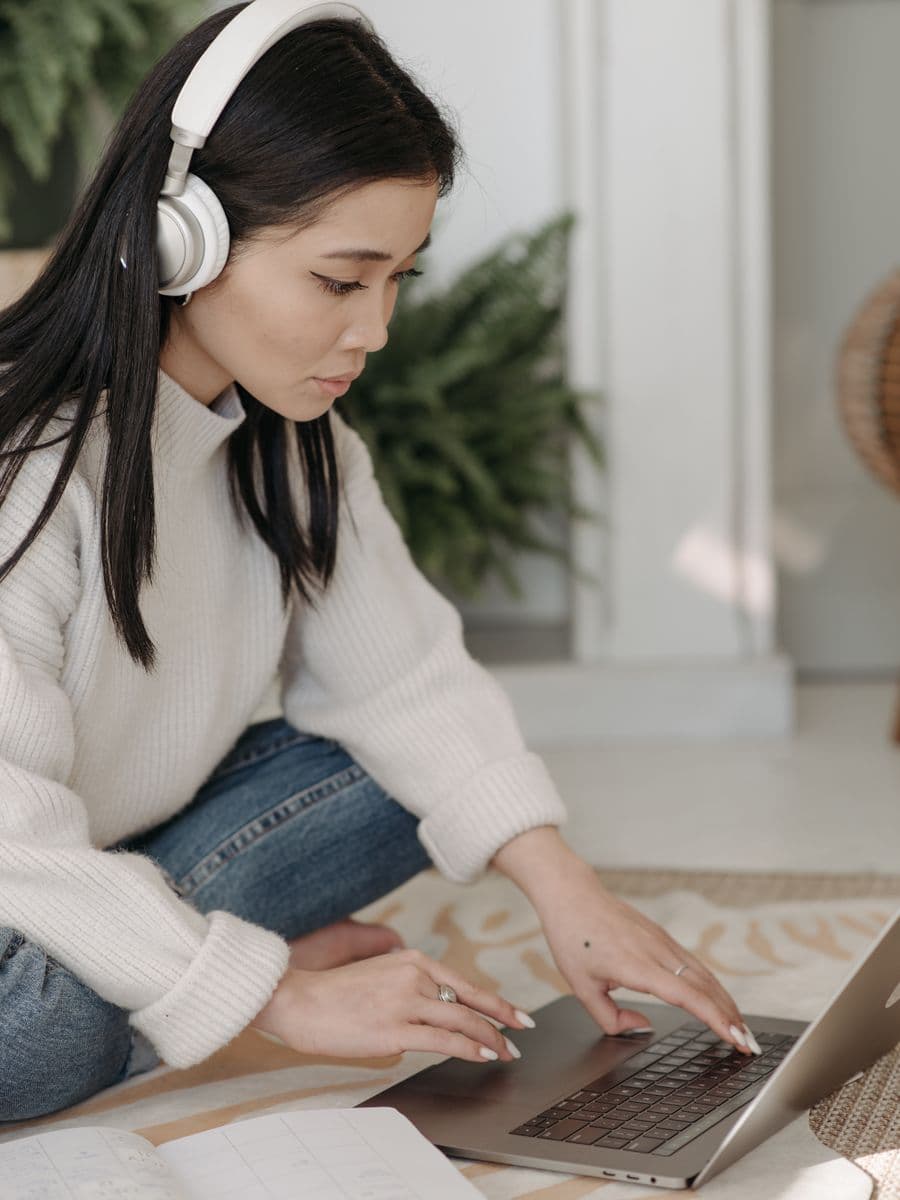Video editor wearing headphones while working at a computer